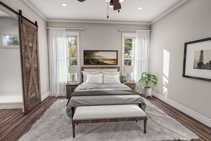 Modern bedroom with wooden floor and decorative sliding door.