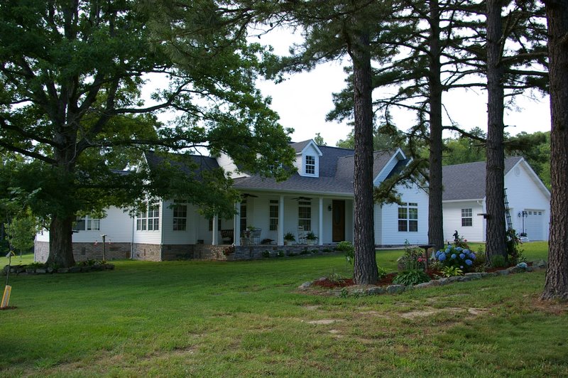 Suburban house with trees and lawn.