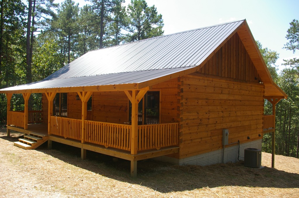 Wooden cabin with porch in forest setting