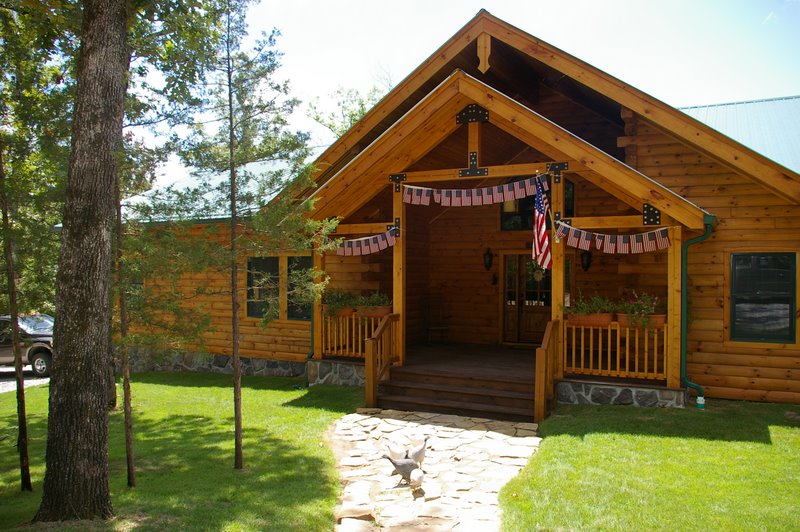 Cozy wooded cabin with American flag decor.