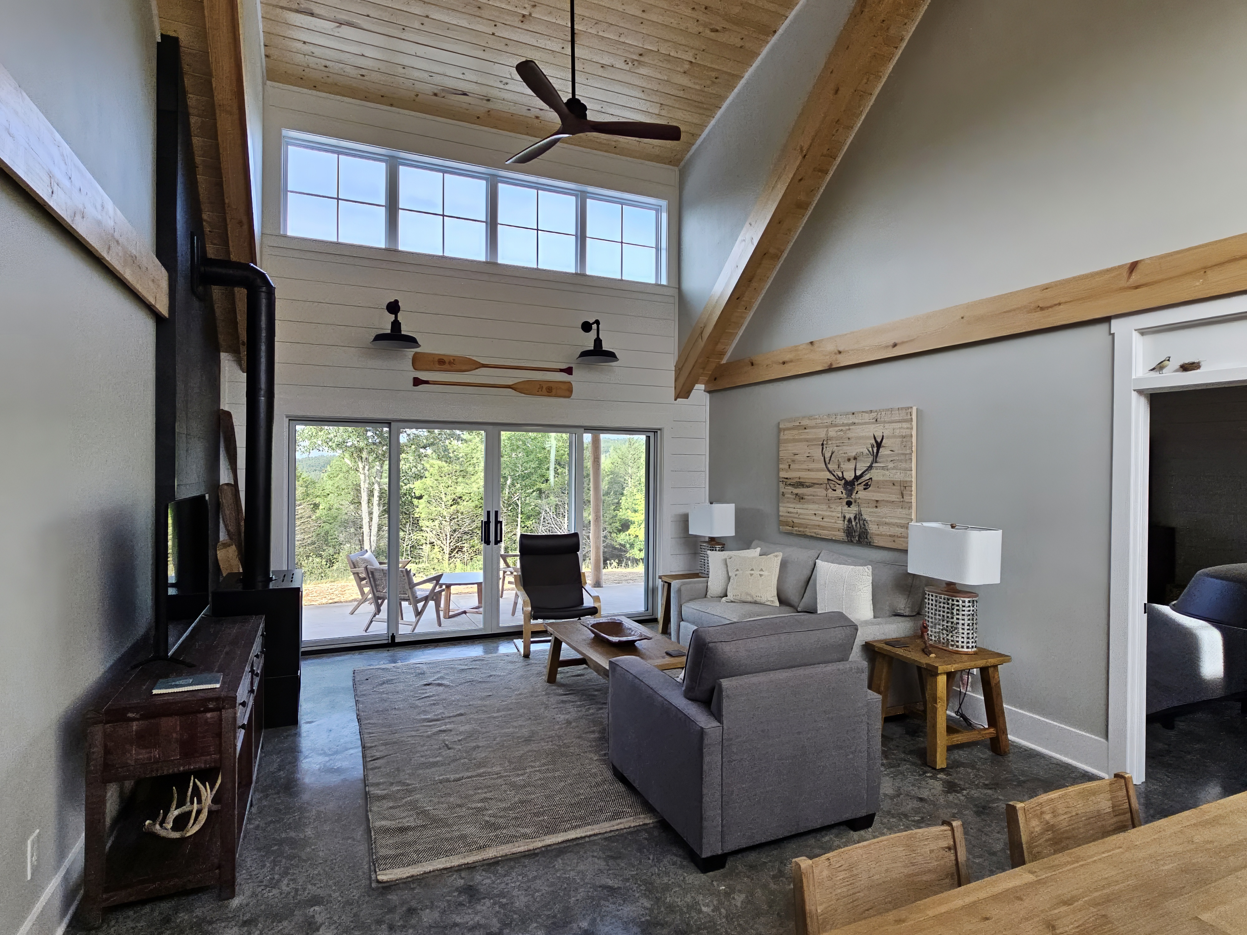 Modern living room with natural light and vaulted ceiling.