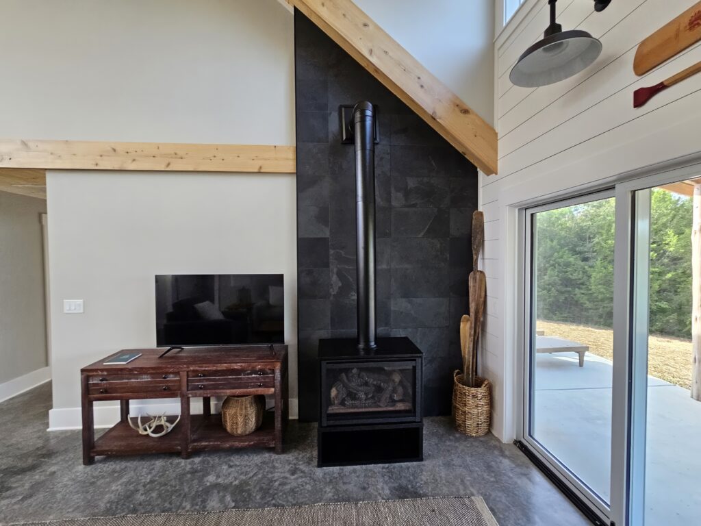 Modern living room with fireplace and sliding glass door.