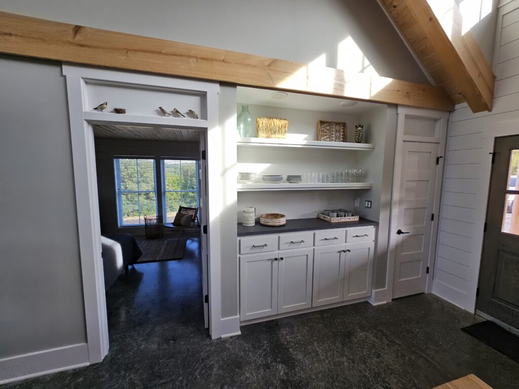 Modern kitchen interior with open shelving and natural light.