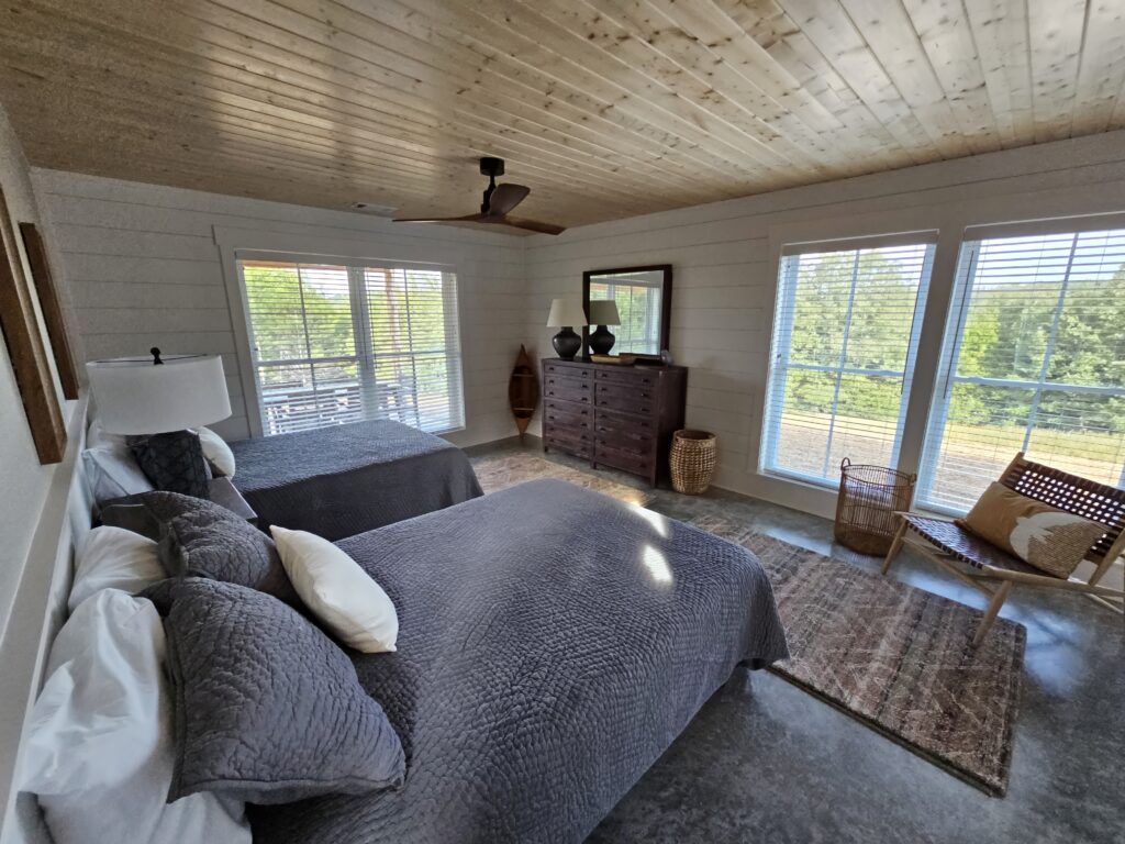 Cozy bedroom interior with two beds and natural light.