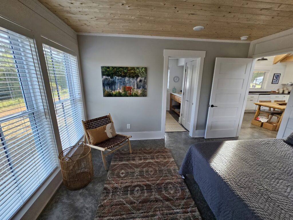 Bright modern bedroom with stylish decor and natural light.