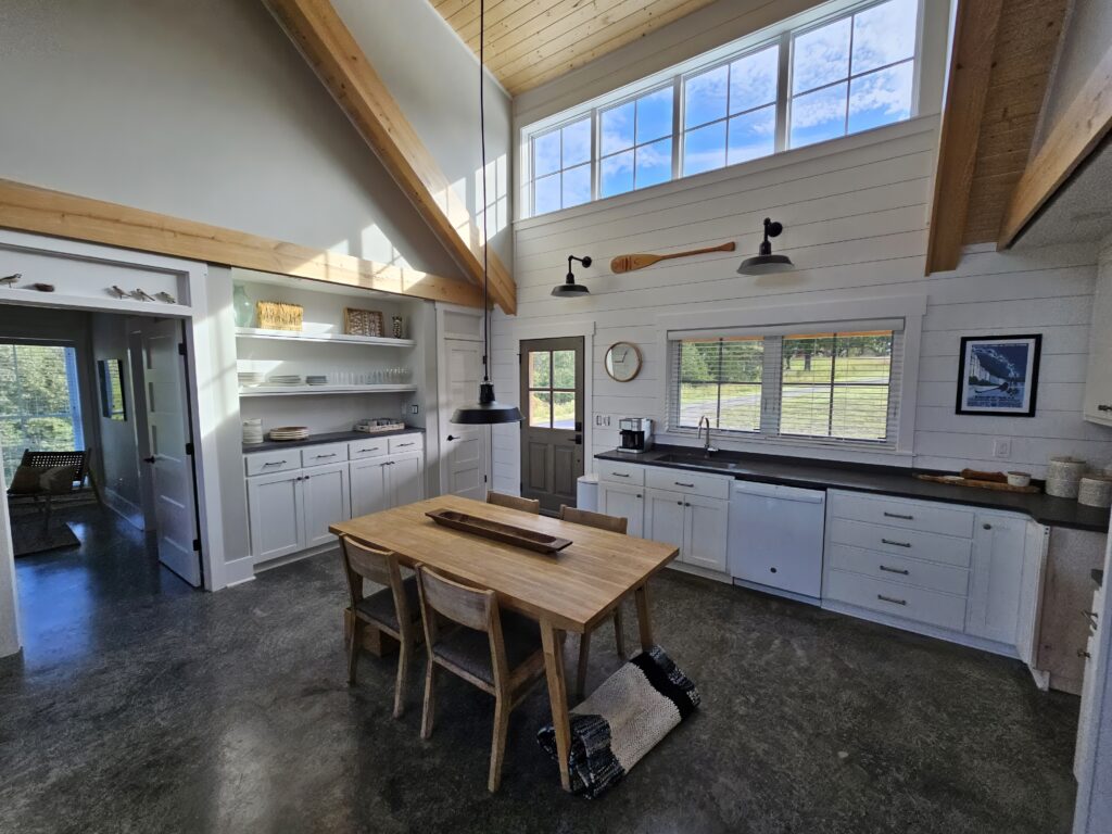 Modern kitchen interior with high ceilings and natural light.