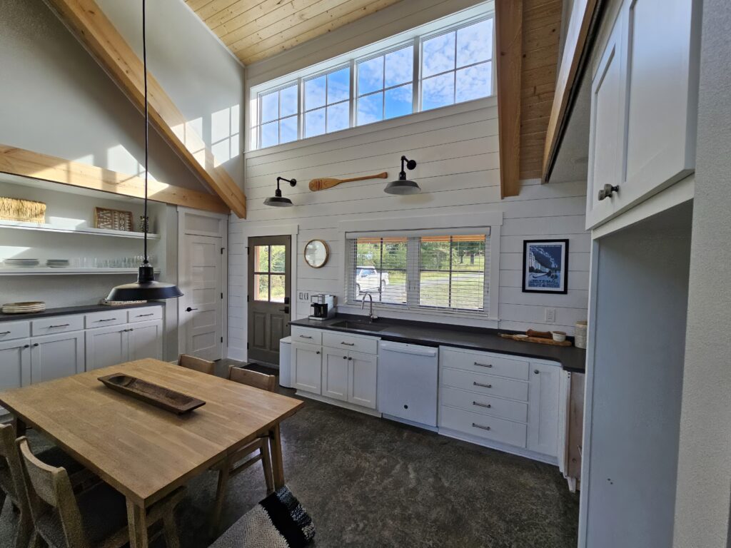 Bright modern kitchen with high ceilings and wooden accents.