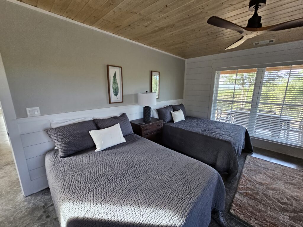 Cozy twin beds in modern bedroom with natural light.