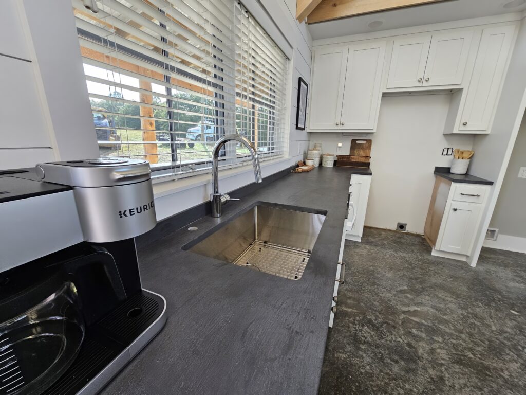 Modern kitchen interior with coffee machine and sink.