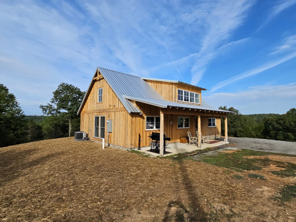 Rustic wooden cabin with metal roof in countryside