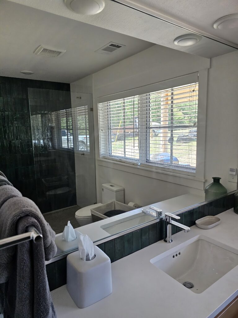 Modern bathroom interior with tiled shower and sink.