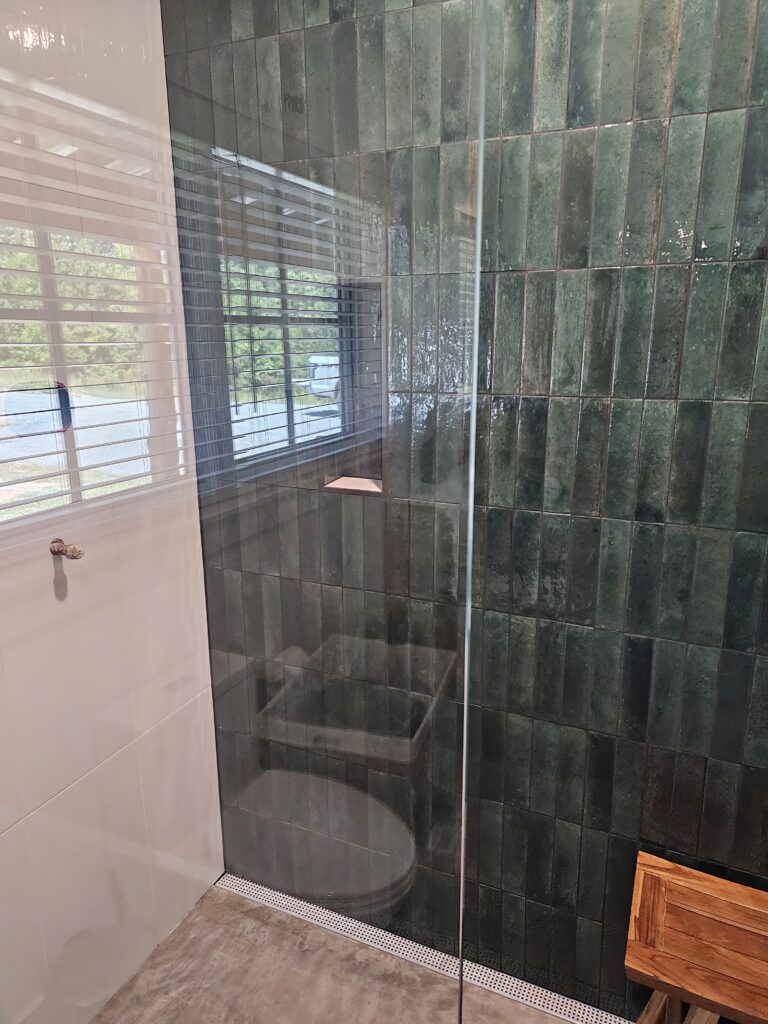 Modern bathroom with glass shower enclosure.