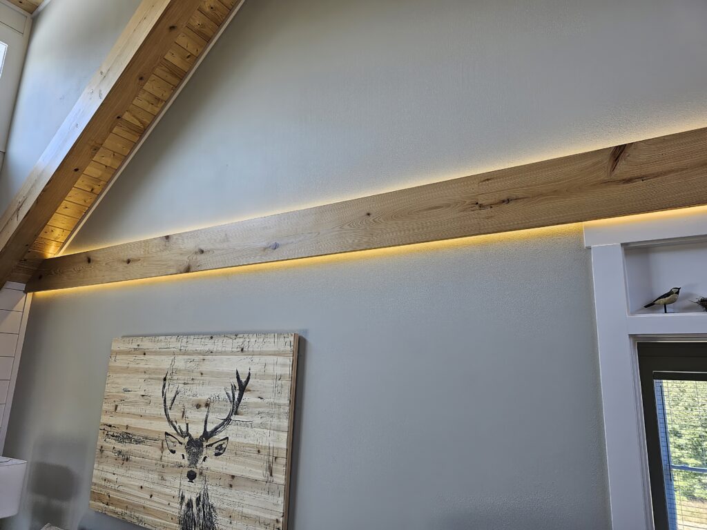 Interior with wooden beams, LED lighting, and deer artwork.