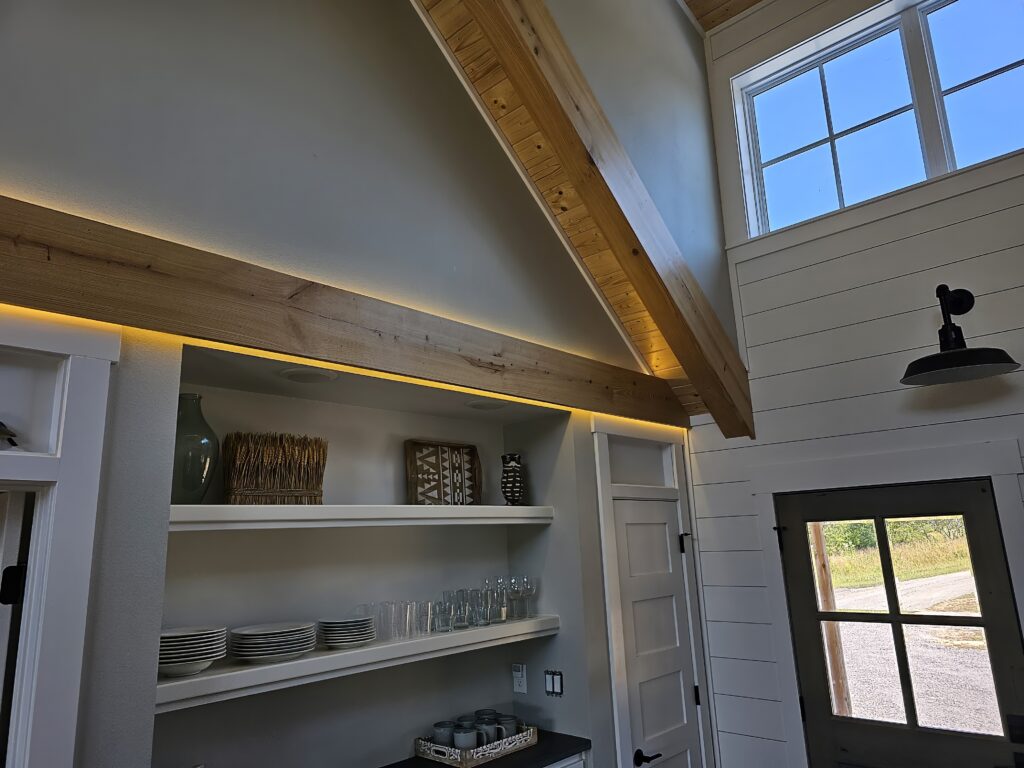 Modern kitchen interior with wooden accents and open shelving.