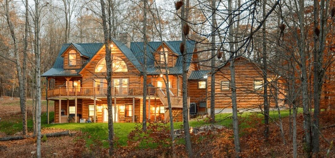 Log cabin in autumn forest at dusk.