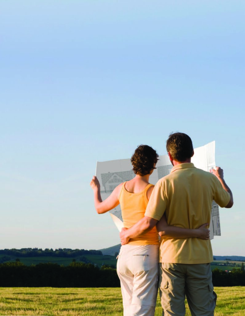 Couple with map overlooking green landscape.